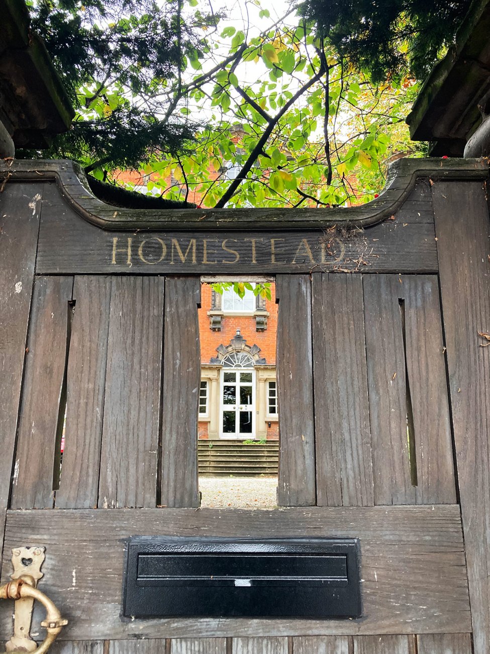 Photograph of The Homestead through the gate